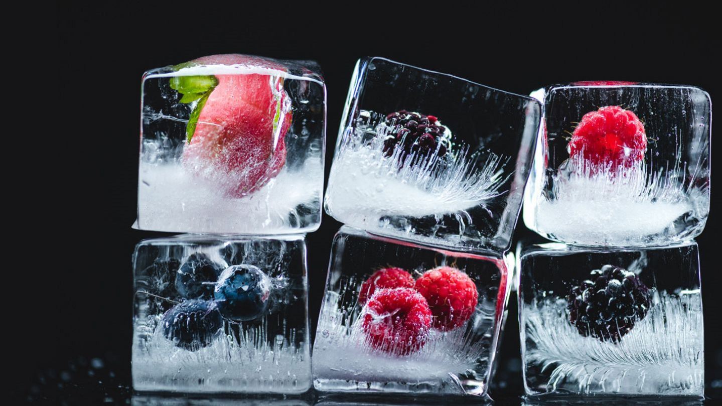 Ice cubes with berries frozen in them